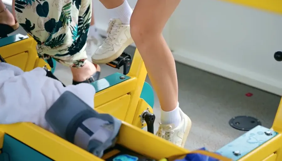 Woman in white sneakers and a yellow suitcase, ready for a bachelorette trip on Paddle Pub