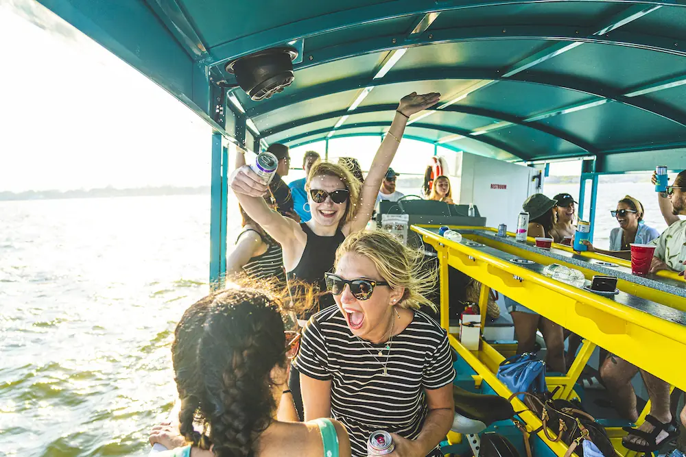 Guests cheering from the pedal stations with the water behind them